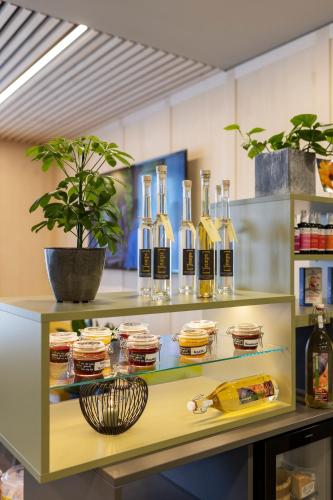 a shelf filled with bottles of wine and food at JUFA Hotel Laterns - Klangholzhus in Laterns