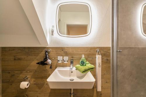 a bathroom with a sink and a mirror at Treibholz - Feriendomizil Ostsee in Schönberger Strand