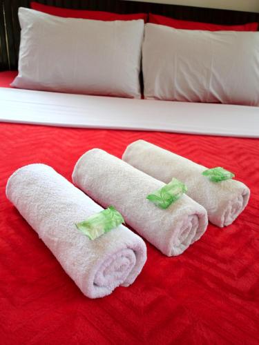 a group of towels sitting on a bed at The Sanduk Homestay in Rantepao
