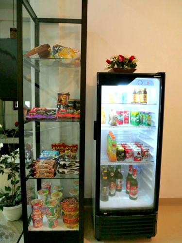 a refrigerator with its door open with food and drinks at The Sanduk Homestay in Rantepao