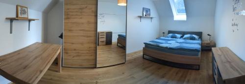 1 dormitorio con 1 cama y pared de cristal en Ferienwohnung Genusshaus TIMIschl, en Sankt Margarethen an der Raab