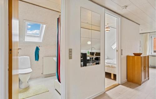 a bathroom with a sink and a toilet in a room at 1 Bedroom Cozy Apartment In Ringkbing in Ringkøbing