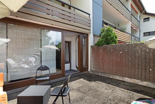 a patio with two chairs and a table and a window at Appartement Arend in Dobel