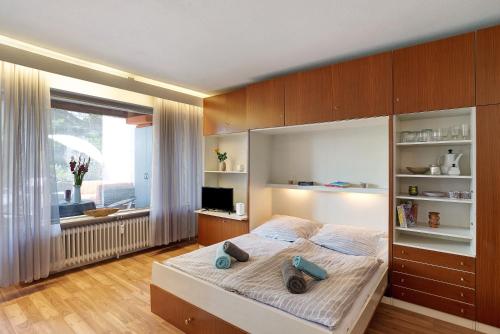 a bedroom with a large bed with wooden cabinets at Appartement Arend in Dobel