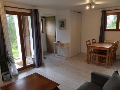 a living room with a table and a dining room at New studio ground floor in the heart of nature in Châtillon-sur-Cluses