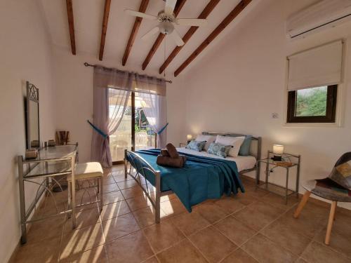 a bedroom with a bed and a couch in a room at Cyprus style Stone Villa in Paphos City