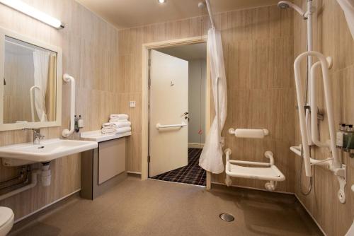 a bathroom with a sink and a shower at The Coniston Inn - The Inn Collection Group in Coniston