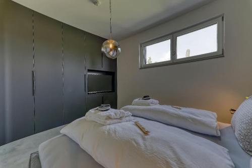 a bedroom with two beds with towels on them at Chalet Panorama in Freyung