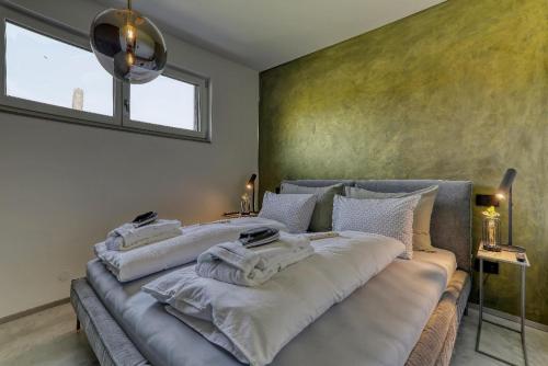 a bedroom with a bed with white towels on it at Chalet Panorama in Freyung