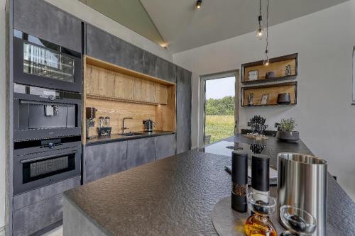 a kitchen with a counter with a stove top oven at Chalet Panorama in Freyung