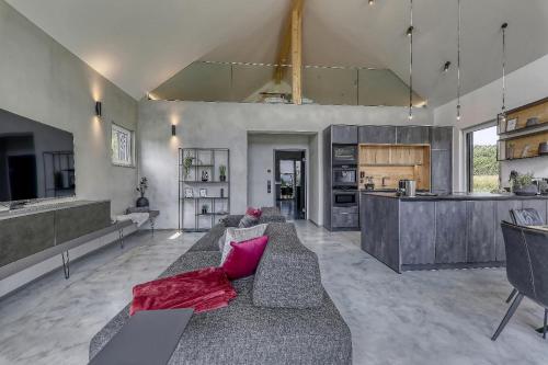 a large living room with a couch and a kitchen at Chalet Panorama in Freyung