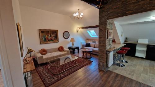 a living room with a couch and a table at La Cigogne in Château-Thierry