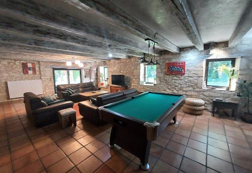 a living room with a pool table in it at Le Moulin de Bernard in Saint-Pantaléon