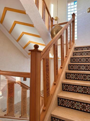 a staircase with wooden railings in a house at AYOR FES in El Oulaij