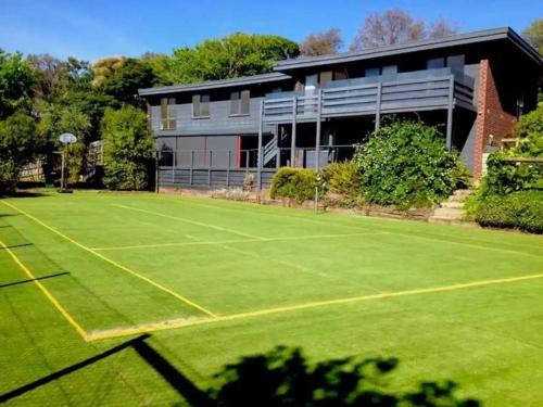 a tennis court in front of a building at Haven at Rye by Ready Set Stay - BYO LINEN & TOWELS in Rye