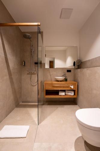 a bathroom with a shower and a sink and a toilet at Aparthotel nah dran in Dingolfing
