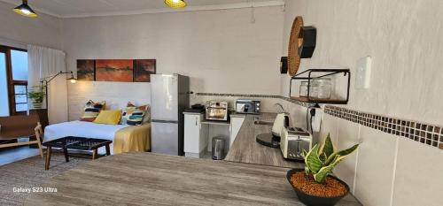 a room with a kitchen and a room with a bed at Parsons Hill Apartment in Glendinningvale