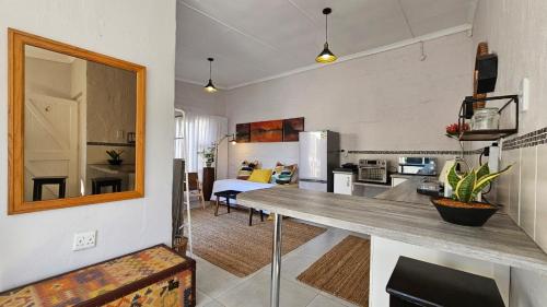 a kitchen and living room with a table in a room at Parsons Hill Apartment in Glendinningvale