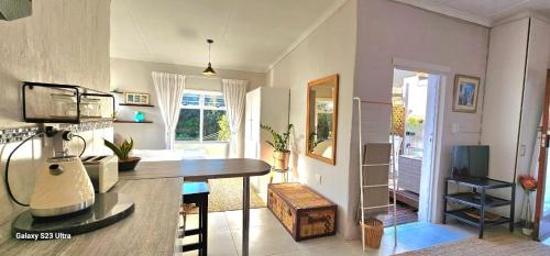 a kitchen and living room with a table and a living room at Parsons Hill Apartment in Glendinningvale