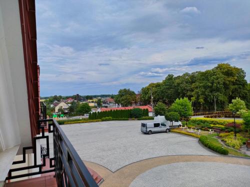 a white truck parked in a parking lot at Hotel Viwaldi in Baruchowo