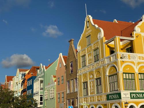 a row of colorful buildings on a street at La Vista Luxury Apartment Jan Thiel in Jan Thiel