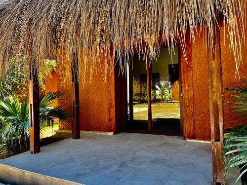 an entrance to a building with a straw roof at LE VAHINÉ Eco-RESORT in Toliara