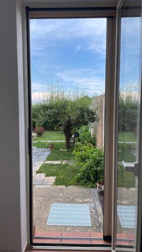 a sliding glass door with a view of a yard at Bio&B Acquaviva in Otranto