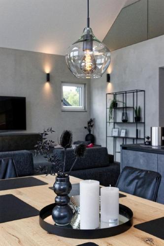 a dining room table with a vase with flowers on it at Chalet Panorama in Freyung