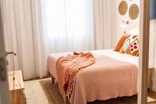 a bedroom with a bed with a blanket on it at Azores Green Villas in Ponta Delgada