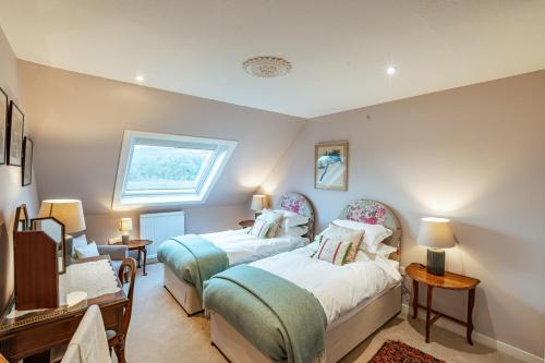 a bedroom with two beds and a window at Kenmure Kennels in New Galloway