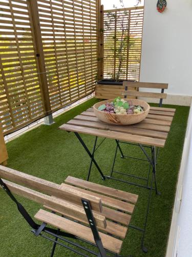 a picnic table and bench with a bowl on it at Dimore Capirro Charming Family House in Trani