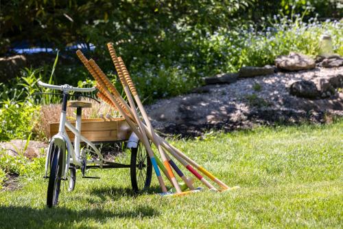 a cart full of baseball bats sitting in the grass at The Villa Bed and Breakfast in Westerly