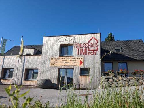 a building with a sign on the front of it at Ferienwohnung Genusshaus TIMIschl in Sankt Margarethen an der Raab