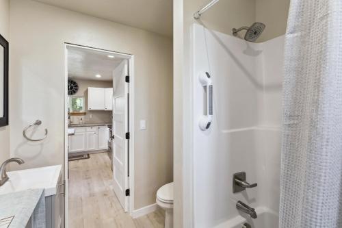 a white bathroom with a toilet and a sink at Lewiston Vacation Rental Near Clearwater River! in Lewiston