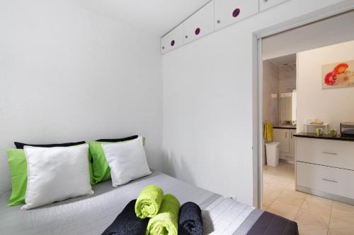 1 dormitorio con 1 cama con almohadas verdes y blancas en Aldeia das açoteias, en Albufeira