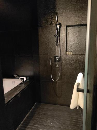 a bathroom with a shower and a sink and a tub at Jiangnan House Chaozhou in Chaozhou