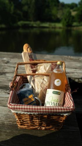a basket filled with food and a bottle of beer at Le Village des Monédières in Chamberet