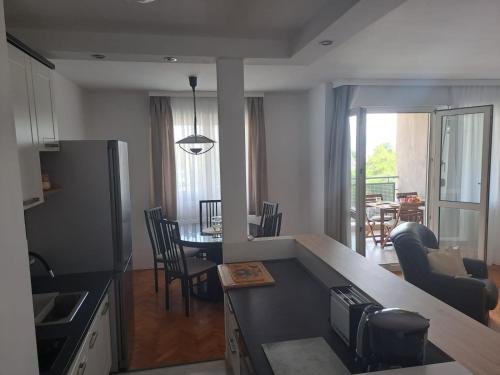a kitchen and living room with a table and chairs at City, sea and river view, Omis in Omiš