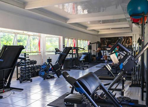 a gym with a bunch of tread machines in a room at Hotel Mitologia Algodoal in Algodoal