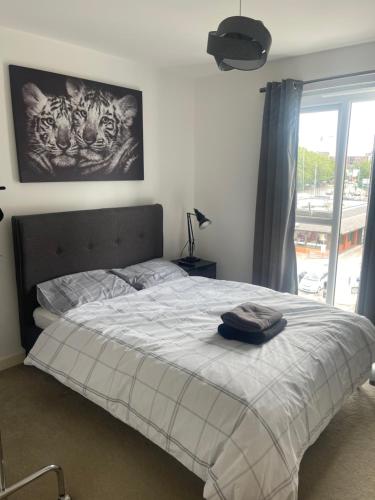 a bedroom with a bed and a window at Home away from home plus free parking spaces in Manchester