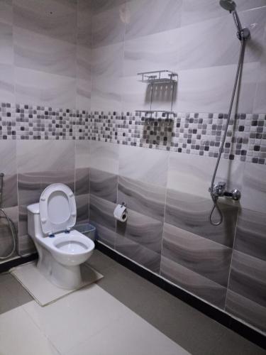 a bathroom with a toilet and a shower stall at برج الراية للشقق المخدومة in Riyadh