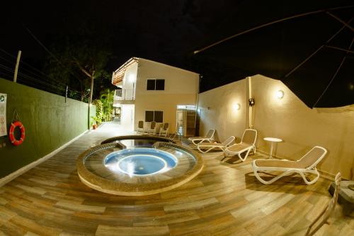 a hot tub in the middle of a patio with chairs at Hotel Isla Bonita in San Andrés