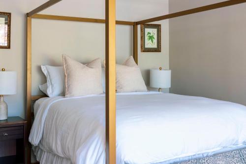 a bedroom with a large bed with white sheets and pillows at The Villa Bed and Breakfast in Westerly