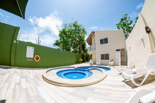 a backyard with a pool and chairs and a building at Hotel Isla Bonita in San Andrés