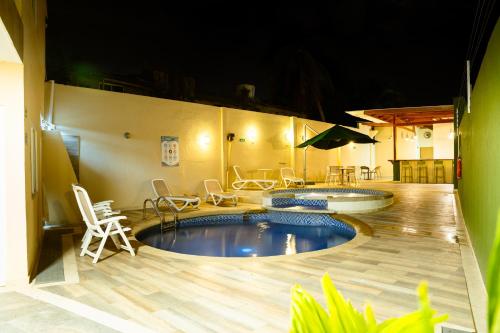 a large swimming pool with chairs and a table at Hotel Isla Bonita in San Andrés