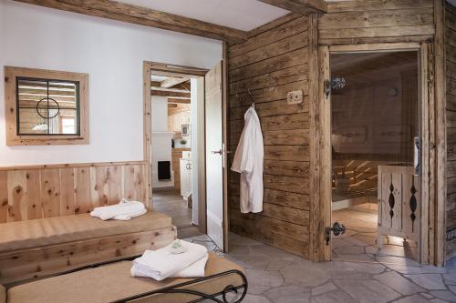 a bathroom with two beds in a room at Feriendorf Holzlebn in Grossarl