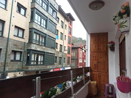a balcony with a view of a building at Apartamento Casa Belén Arriondas in Arriondas