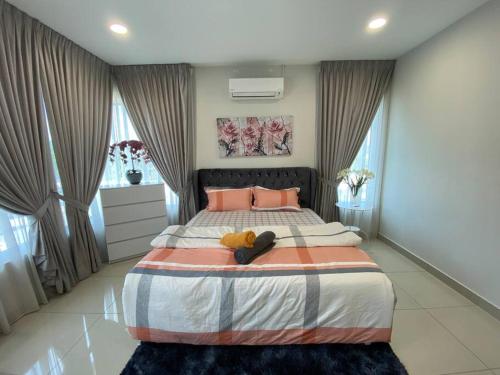 a bedroom with a large bed with a teddy bear on it at Renai Homestay - 10 PAX, NETFLIX in Shah Alam