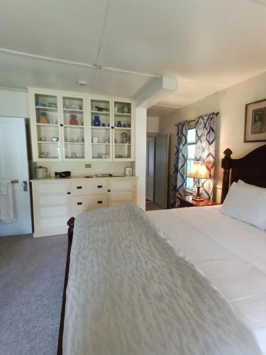 a bedroom with a large white bed and a window at Arlington Inn & Spa in Arlington