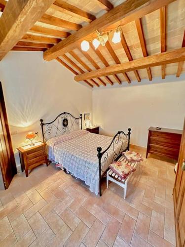 a bedroom with a bed and a wooden ceiling at La Casetta in Orvieto Scalo